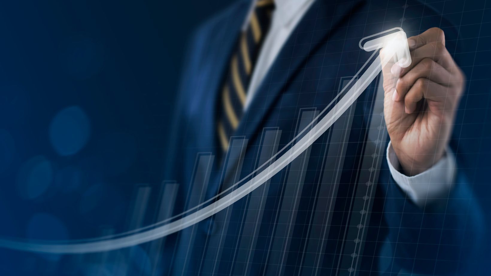 A man in a suit in the background outlining a growth graph