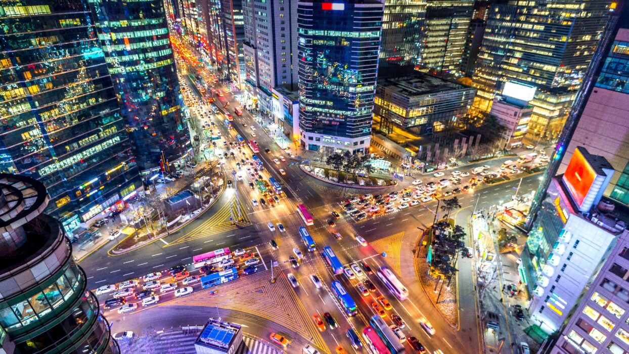 Gangnam intersection at night with cars speeding