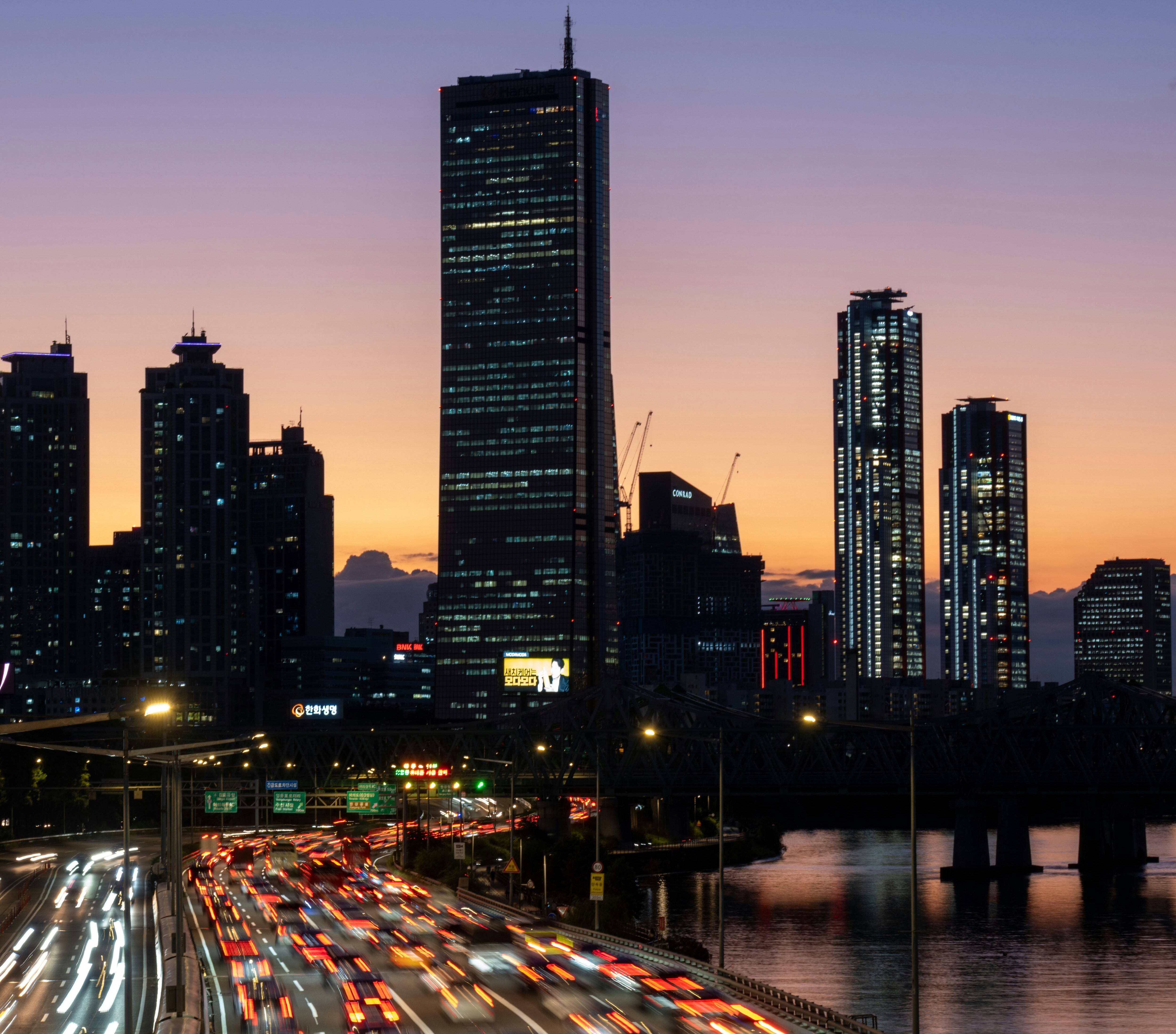 Yeouido skyline at sunset above a trafficked road