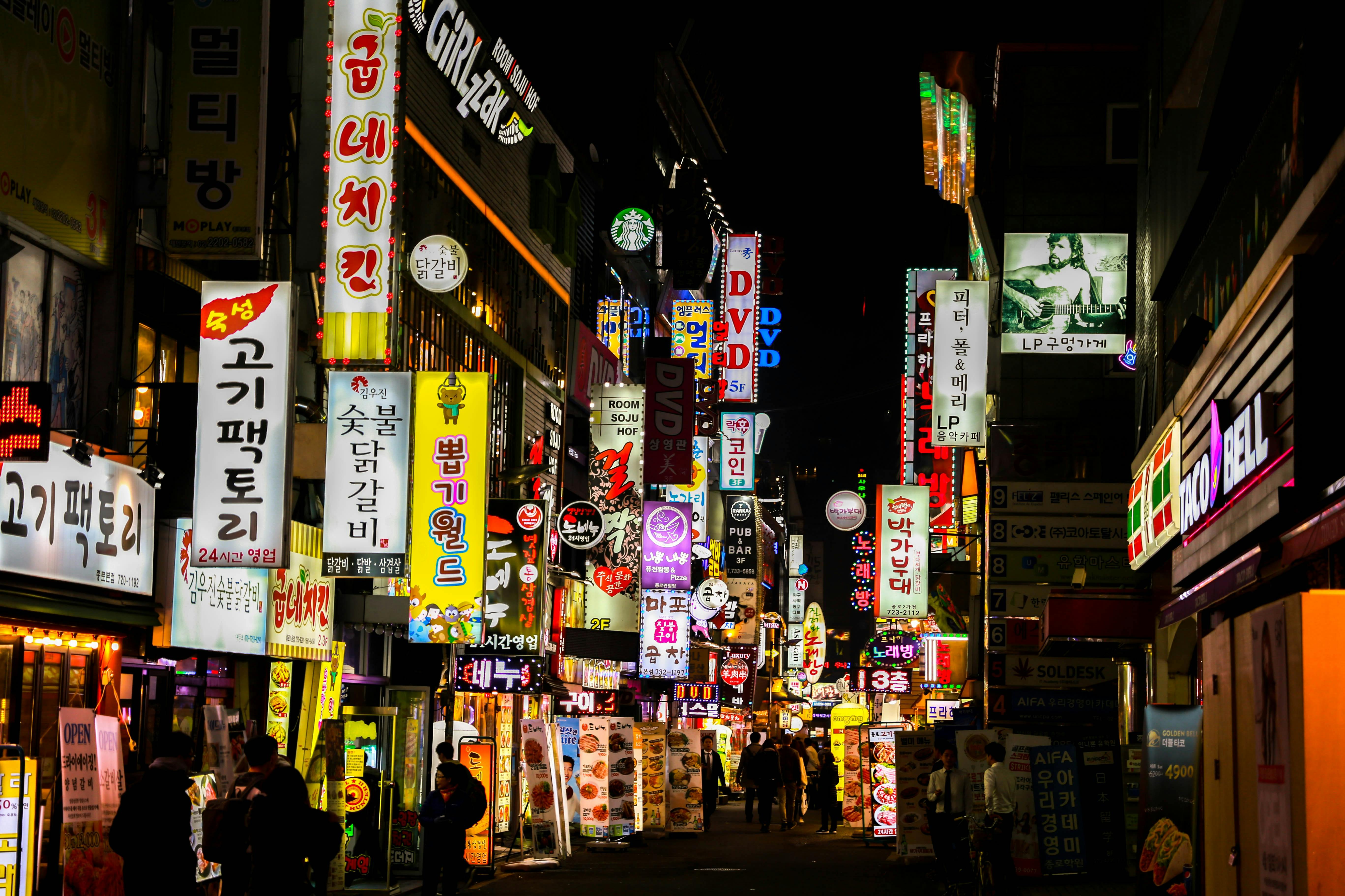 An alley in Seoul illuminated by many different neon signs